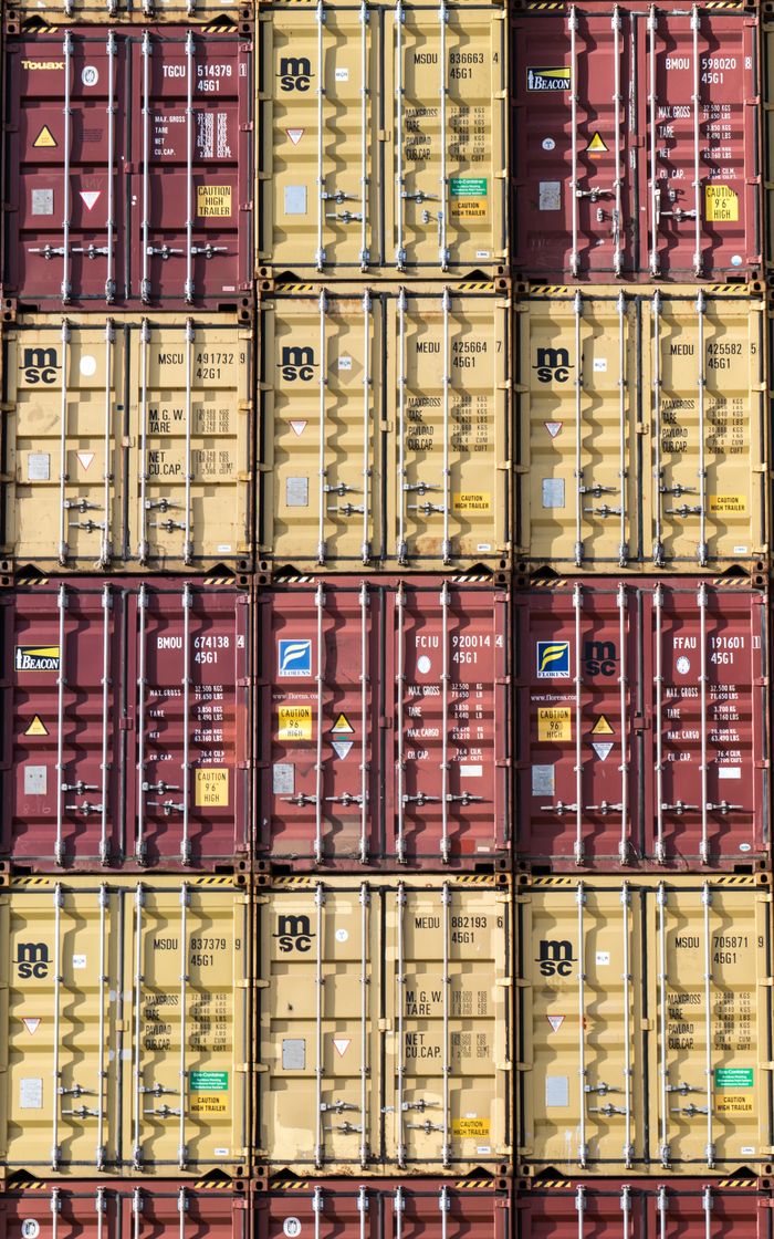 portfolio-02 Vertical stack of red and yellow shipping containers, illustrating global logistics.