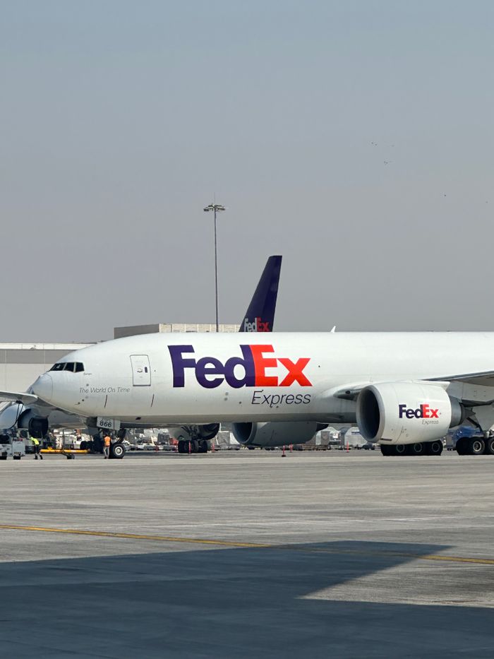 gallery-05 FedEx cargo aircraft parked at Dubai International Airport on a clear day.