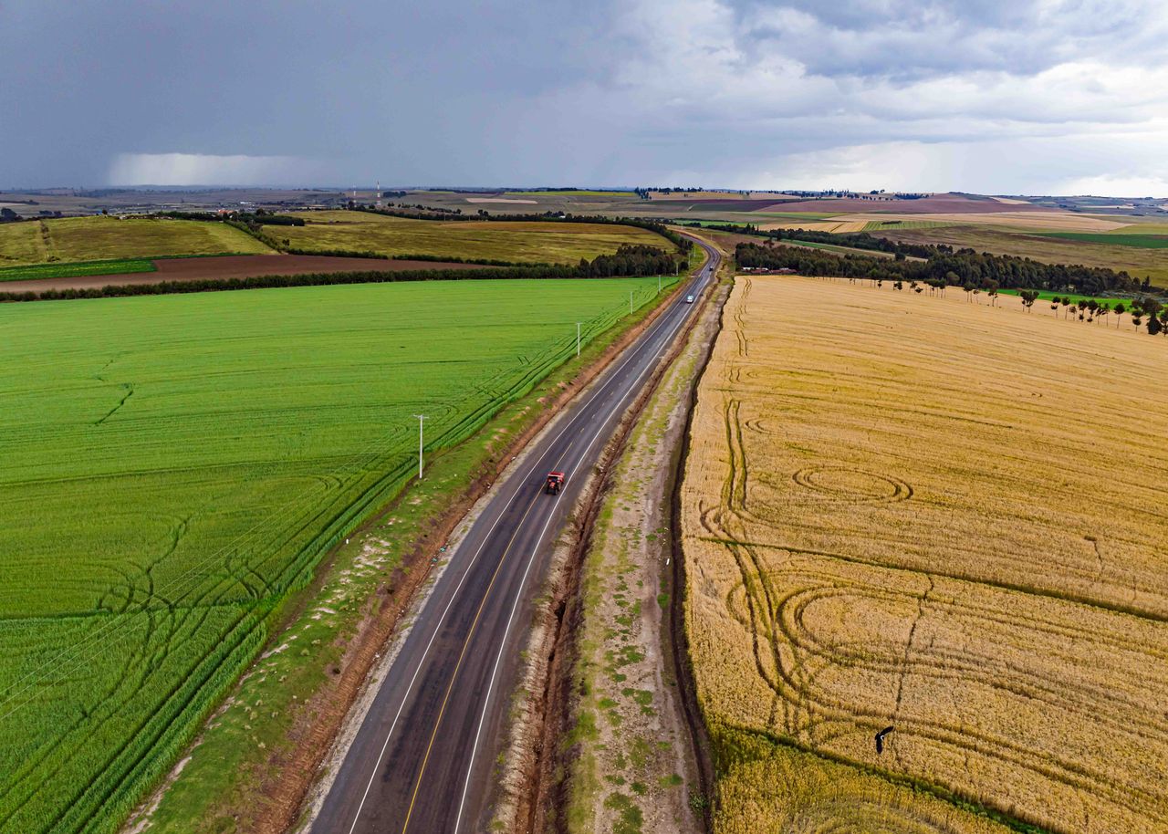 Scenic aerial view of a rural road between fields in Mau Narok, Kenya. Perfect for travel and nature themes.